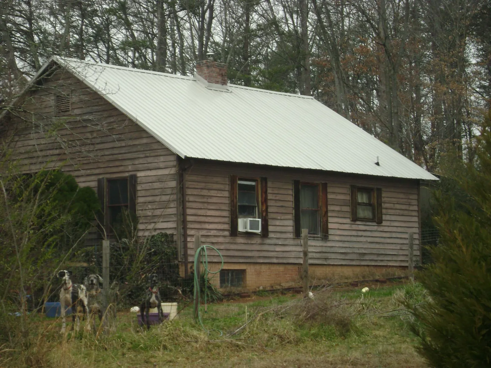 White metal roof on an old wood sided farmhouse, from a Asphalt Shingle Roof Repair job in Valley Village